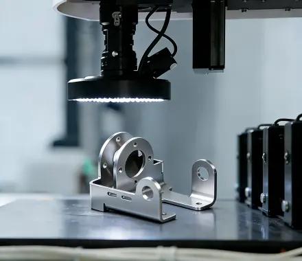 Automated optical inspection of a stamped metal component under ring lighting
